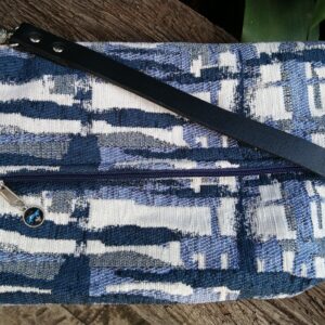 blue and white foldover crossbody bag with leather strap
